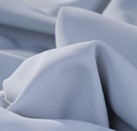 Pružná kostýmová látka pastelové sv. modré barvy