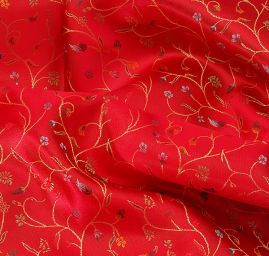 Látka brokát květy na červeném podkladě