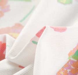 Úplet piké květy oranžovohnědé