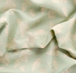 Žakárová látka se vzorem květů v pastel zelené