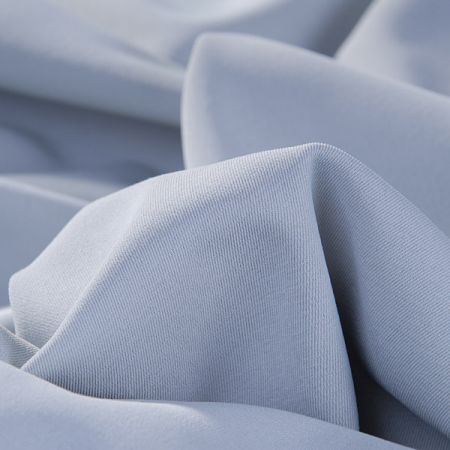 Pružná kostýmová látka pastelové sv. modré barvy