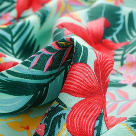 Viskozová šatová látka tropické květy zelená