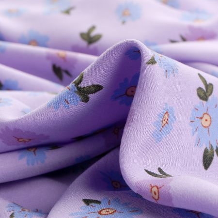 Viskozová šatová látka květy fialovomodré na lila