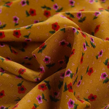 Viskozová šatová látka drobné květy okrová