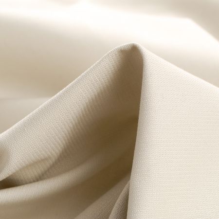 Bavlněná pevnější látka béžovošedé barvy